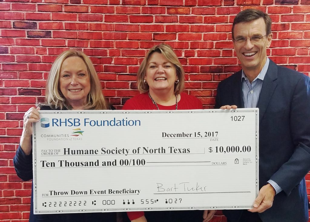 Karen Farris and Bart Tucker present $10,000 check to Humane Society of North Texas