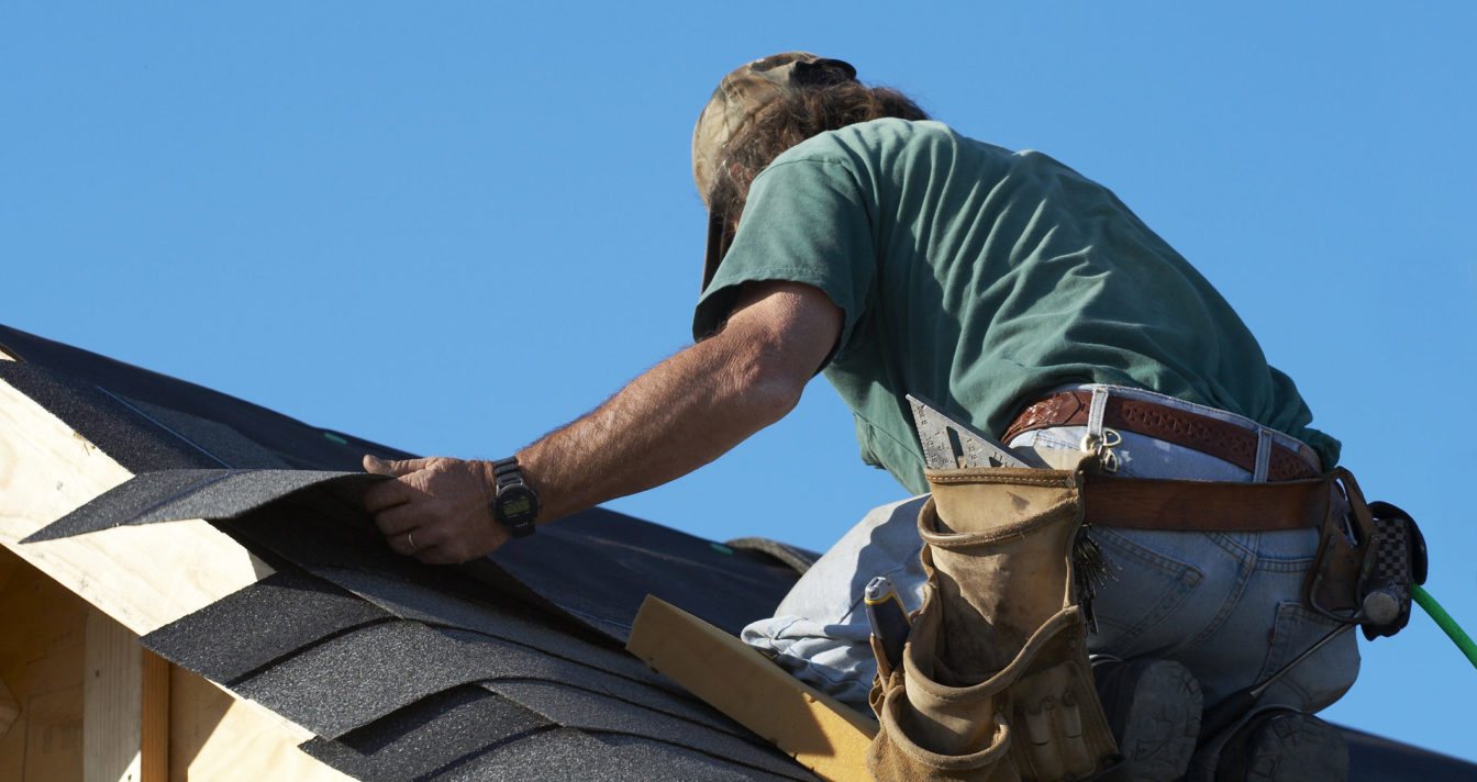 Construction worker working on the roof Construction worker working on the roof
